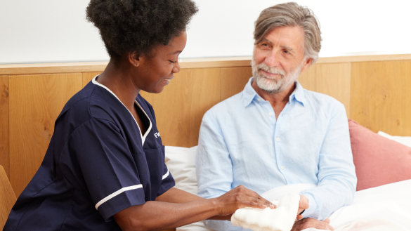 Florence nurse taking care of male patient in bed